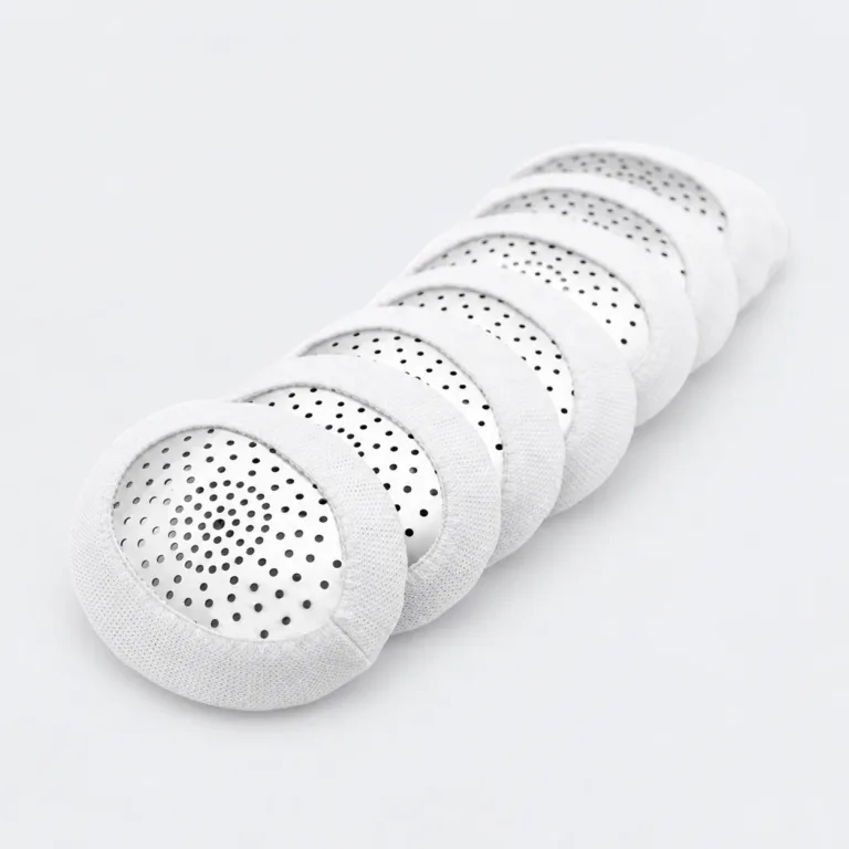 Stack of Fox aluminum pinhole eye shields with white loop covers